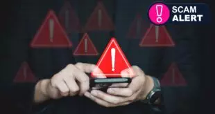 A person holding a phone looking at a scam text with warning signs around